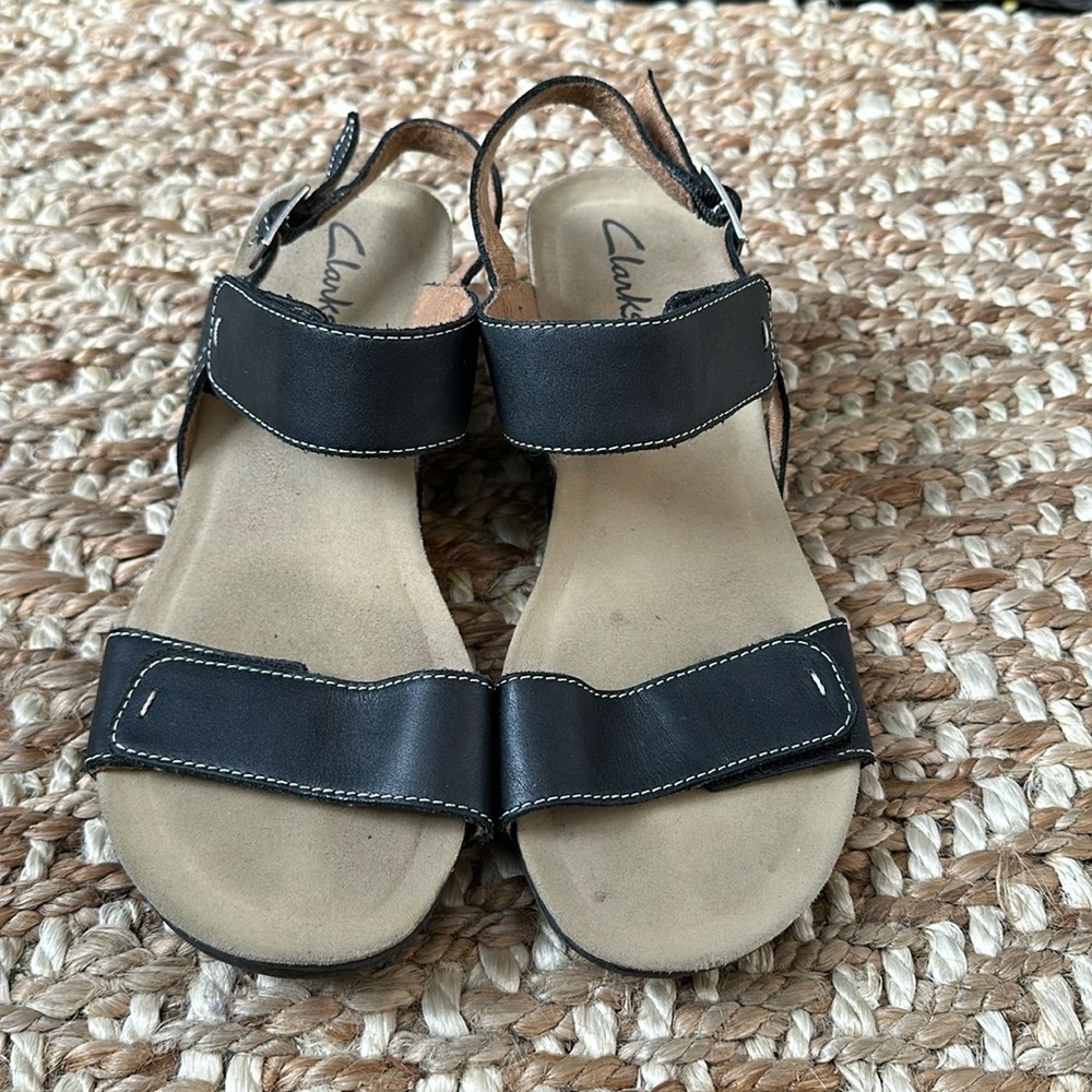 Clarks Black Leather Sandal
Adjustable Heel and Foot Strap
Women's Size 8.5 M